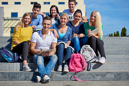 校外学生坐在台阶上学校生活成人微笑女士青少年女孩友谊大学朋友们图片