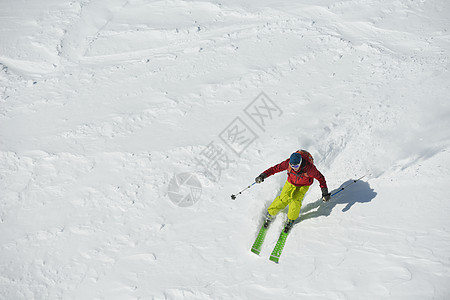 滑雪车乐趣衣服下坡蓝色天空男人太阳粉末空气自由图片