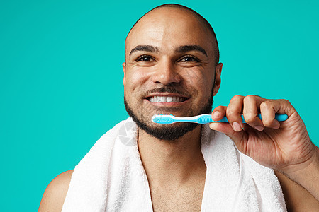 深肤色的黑皮肤男性 用绿绿石背景来刷牙快乐保健牙齿幸福刷子卫生牙刷牙膏工作室成人图片