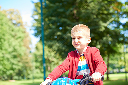 在公园骑自行车的男孩活动学习乐趣安全童年微笑行动平衡轮子头盔图片