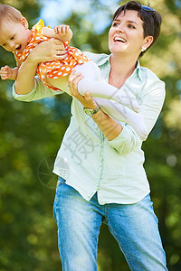 公园中的母亲和婴儿学习孩子脚步妈妈女儿拥抱家庭父母乐趣童年图片