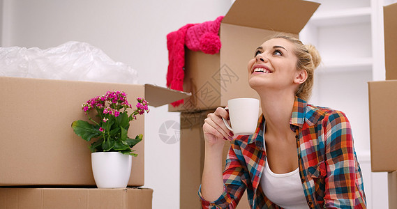 坐在地板上有许多妇女用纸板箱女孩成人女士包装财产搬迁公寓房间盒子纸板图片