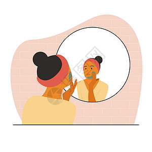 棕色皮肤的妇女坐在镜子前 用面罩蒙住脸部图片