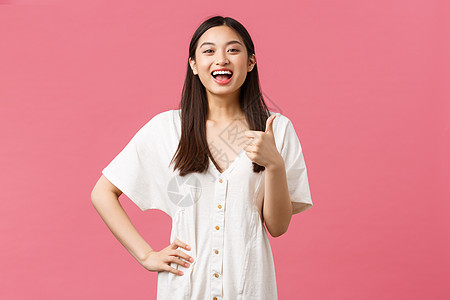 美 人的情感与夏季休闲度假理念 快乐 满意的亚洲女性顾客在店里竖起大拇指 笑着乐观 推荐参观地点 粉红色背景图片