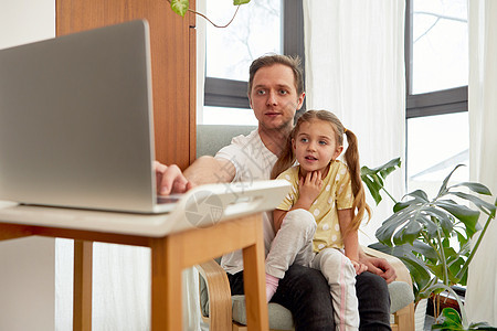 父亲和女儿在家使用笔记本电脑孩子们家庭卡通片女孩父母教育娱乐婴儿工具童年图片