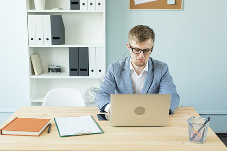 商业 技术和人的概念     手持笔记本电脑的英俊男子男性创造力公司工作桌子男人办公室职场药片艺术家图片