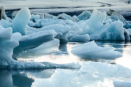 Jokulsarlon冰川湖太阳蓝色天空旅游冰山融化海滩海洋旅行冰川图片