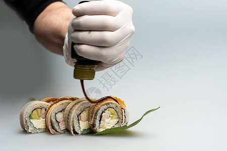 准备日本食物的厨师手特写镜头 日本厨师在餐厅制作寿司 供应传统日本寿司的年轻厨师橙子烹饪健康推介会美食盘子展示男人厨房服务图片