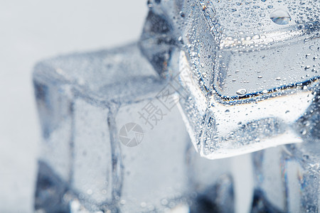 与水滴相近的冰雪立方体  在白色背景的宏中上升 正在刷新冰层蓝色水晶食物工作室玻璃冷藏气泡反射冰块冰镇图片