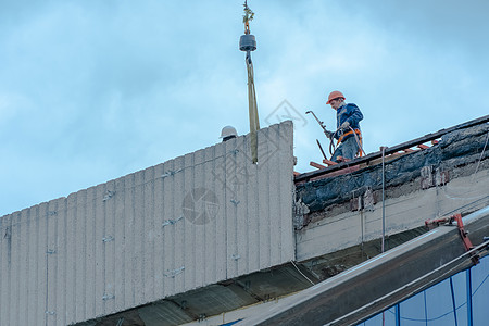 莫斯科 俄罗斯 05 10 2021 建筑物的修复 重建和维修 戴安全帽的建筑工人在结构的屋顶上安装混凝土板 房屋修复施工员工工图片