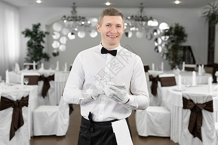 穿着白衬衫和领结的侍者 在咖啡馆写下订单图片