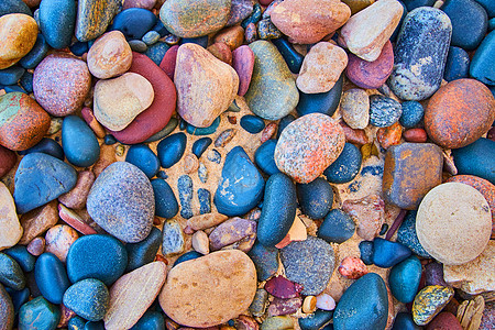 平滑多彩色石头对沙沙滩图片