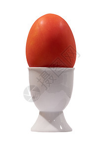 鸡蛋杯 在白桌顶的鸡蛋杯里吃番茄图片