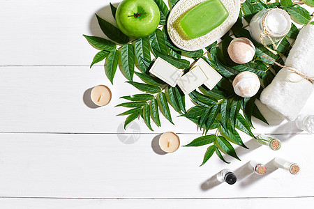 用毛巾和肥皂装在白木背景上 绿色叶子身体香气疗法皮肤蜡烛浴室玻璃护理女性草药图片