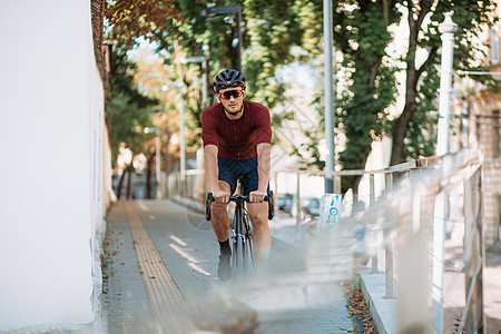 身戴安全头盔的健壮男子在户外骑自行车练习图片
