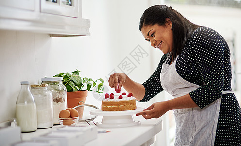 我最喜欢的就是烘烤 一个在厨房里装饰蛋糕的女人被割了一针图片