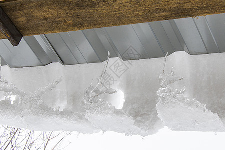 屋顶 白天空和冰水的冰柱 冬天房子建筑水晶窗户蓝天冻结天空季节风险危险图片