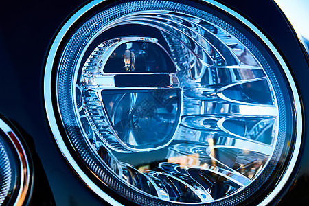 豪华轿车的头灯细节 塞丹头罩的缝合 汽车头灯的背景图片
