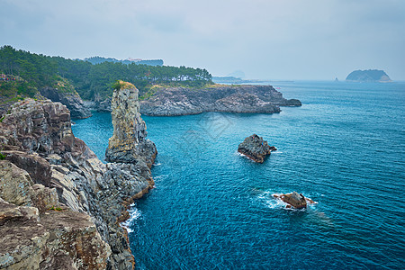 南韩济州岛海洋海岸旅行火山游客石头爬坡风景吸引力岩石图片