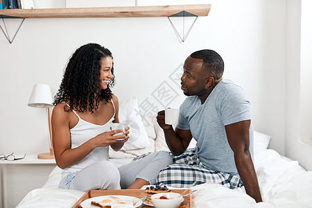 一对快乐的年轻夫妇白天在家一起在床上吃早饭 拍摄到的一张照片 来杯咖啡让我们每天保持清醒图片