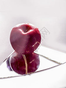 破碎的镜子上的红苹果粉碎损害玻璃裂缝碰撞水果危险红色反射食物图片