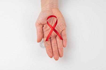 白底带红丝带的女性手掌 是防治艾滋病斗争的标志帮助感染机构疾病女士诊断癌症杯状手指乐队图片