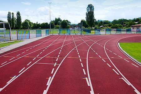 运动体育场的红色赛马赛道蓝色运动员竞赛车道速度场地竞争短跑马场曲线图片