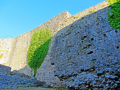 一座古老堡垒的废墟 一座欧洲堡垒的古老厚石墙 山上长满了绿色植物 防御工事废墟中的门和拱门历史性旅游地标遗产岩石建筑学城市建筑蓝图片