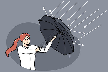 女商务人士使用保护伞来保护雨体图片