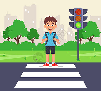 一个小男生在斑马十字路口 穿过一条通往绿灯的道路图片