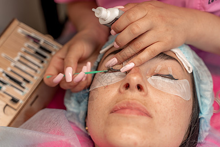 眼睫延伸程序 长眼睫毛的女性眼睛 鞭打 闭合 宏观 有选择的焦点胶水睫毛膏造型治疗沙龙皮肤体积女士女孩层压图片