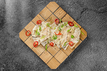 木板上叫做Gyoza的子 亚洲传统快餐 用肉和蔬菜填满了大碗 很少只吃肉烹饪餐厅水角美食沫沫贴纸水饺筷子面团食物图片