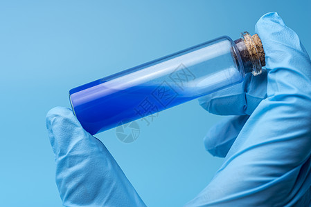 在医学试验期间 将科学家手中含蓝液的玻璃管闭合图片