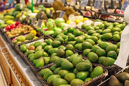 水果超市超市里一连串新鲜绿色鳄梨背景