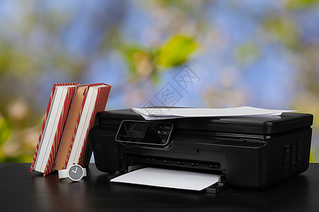 在模糊背景下堆放书本和家用打印机办公室工作黑色文书技术激光商业电子产品墨水扫描器黑色的高清图片素材