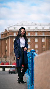 留着长长的黑发的迷人 体贴 穿着时髦的女人穿越欧洲 站在圣彼得堡市中心 一个美丽的女孩独自徘徊在秋天的街道上城市头发建筑外套寂寞背景图片