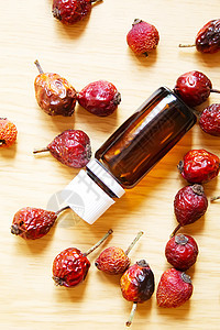 瓶子里的玫瑰芯种子基本油 有选择性地集中野蔷薇玫瑰植物药物滴管康复乡村水果叶子浆果图片