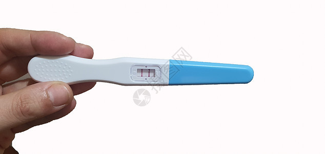 妇女手进行怀孕测试 女性手显示呈阳性怀孕检测结果 怀有婴儿图片