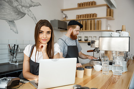 咖啡业务概念美丽的白人调酒师咖啡师或经理在现代咖啡店的笔记本电脑上工作和规划女性服务员食物服务酒吧女士互联网阁楼会计商业图片