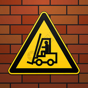 国际安全警告标志 小心 起重卡车 砖墙背景上的标志 黄色三角形上的黑色图像图片