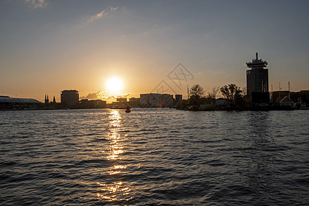 日落时从荷兰阿姆斯特丹港建筑学旅行建筑市中心风光旅游天际中心港口车站图片