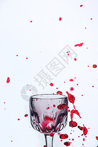一杯红酒在白色背景的杯子上喷洒酒精酒杯食物藤蔓运动玻璃红色行动液体器皿图片