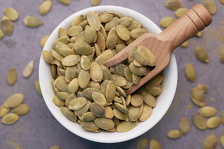 黑底小碗中南瓜种子南瓜棕色植物生物粮食节食绿色食物营养农业图片