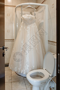 婚纱挂在浴室的淋浴摊间上图片