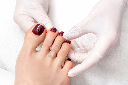 手持涂漆的脚趾甲身体指甲化妆品保健赤脚沙龙女性水疗美容手指图片