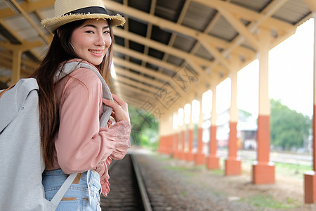 在火车站背着背包的女人背包客旅行者 旅行旅行概念铁路女性游客帽子车站火车女士生活平台运输图片