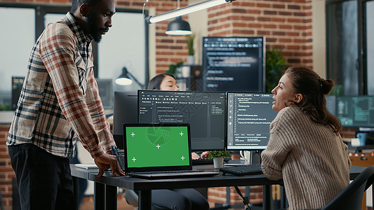 配有多台计算机屏幕和带绿色屏幕染色体钥匙模型的笔记本电脑的程序员商业数据库数据软件创新展示编码色度风暴互联网图片