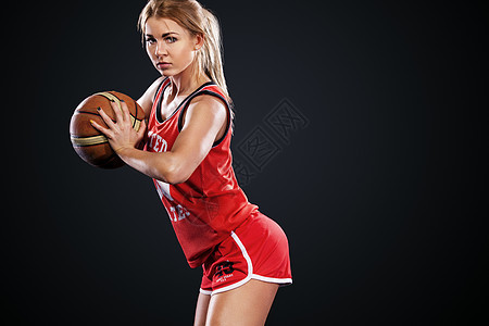 一个在演播室打篮球的美女和女人的肖像 黑人背景上的体育概念短裤训练闲暇时尚青年游戏运动行动女孩篮球图片