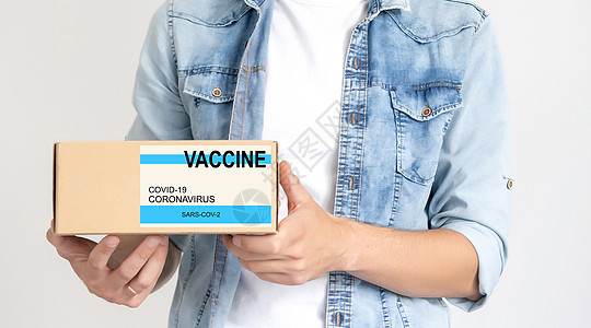 将VACCINE标签贴在纸板盒上防护服食物手套员工服务邮政危机保健导游船运图片