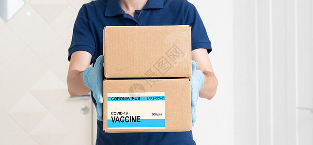 将VACCINE标签贴在纸板盒上纸板房子卫生男人感染冒险防护服运输顾客卡车图片